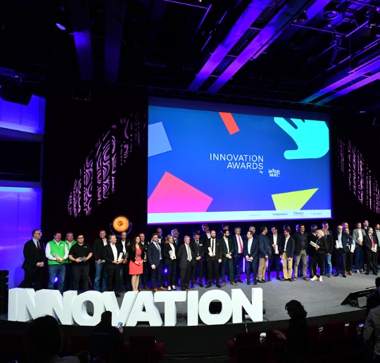 group of professionals in front of a giant screen for the innovation awards at INTERMAT 2024